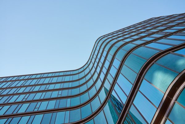 Modern,Building,With,Curved,Glass,Facade,Reflecting,Sky ,Contemporary,Architectural